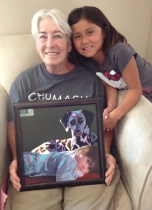 Mom and Isa posing with a painting done by my friend, Melani Guinn.